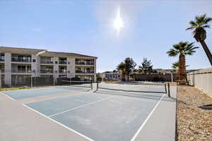 View of tennis court featuring community basketball court