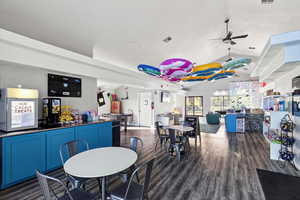 Dining room featuring lofted ceiling, dark wood-style floors, and a ceiling fan