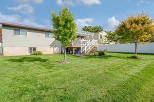 Back of property featuring a wooden deck, stairway, and a metal roof