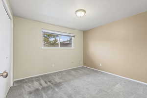 Carpeted spare room with baseboards