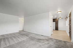 Spare room with light colored carpet and baseboards