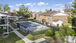 View of tennis court featuring a community pool