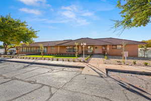 Single story home with a tile roof and stucco siding