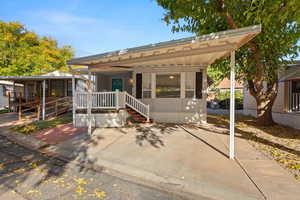 Manufactured / mobile home featuring a sunroom and a wooden deck