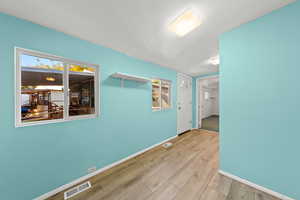 Spare room featuring wood finished floors and plenty of natural light