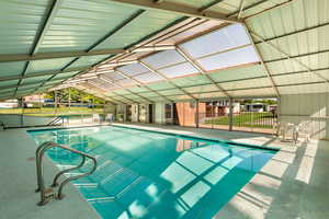 Indoor pool with a lanai and a patio