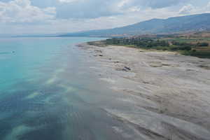 Water view featuring a mountainous background and local beach