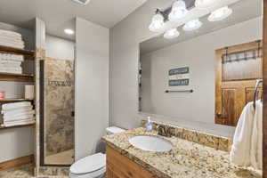 Bathroom featuring vanity and a shower stall