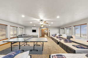 Rec room with recessed lighting, carpet floors, a textured ceiling, and ceiling fan