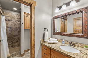 Bathroom featuring a shower stall and vanity