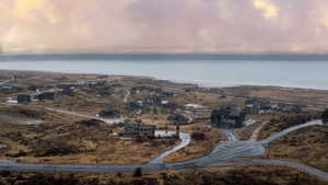 View of property location featuring a large body of water and nearby suburban area