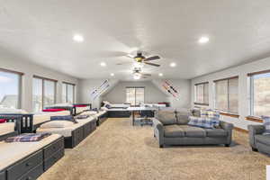 Living room featuring light colored carpet, recessed lighting, a textured ceiling, and ceiling fan