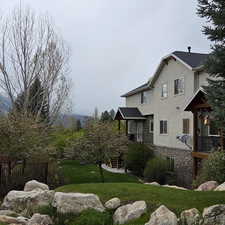 View of property exterior with stone siding and stucco siding