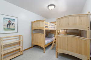 Bedroom with light carpet and baseboards