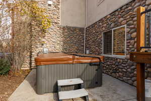 View of patio with a hot tub