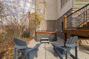 View of patio with a hot tub