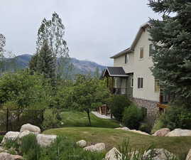 Exterior residence featuring stucco siding and a stone foundation
