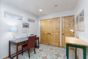 Carpeted home office featuring recessed lighting and baseboards