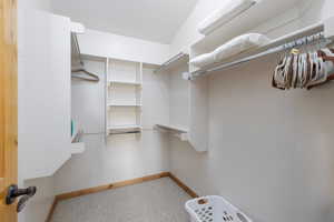 Walk in closet with light carpet