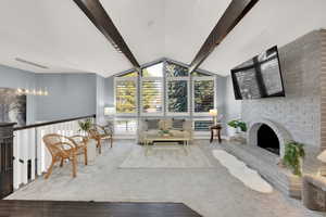 Living area with a fireplace and carpet flooring