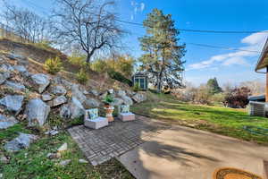 View of patio / terrace featuring a storage shed