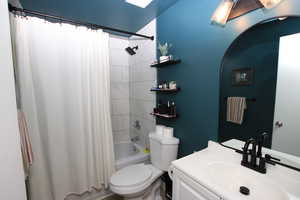 Full bath featuring shower / bath combo and vanity