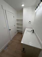 Bathroom featuring vanity, dark wood-type flooring, and a textured ceiling
