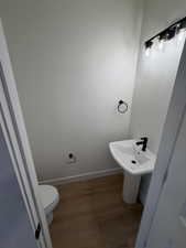 Bathroom featuring wood finished floors and baseboards