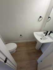 Bathroom with light wood-type flooring and baseboards