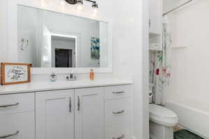 Full bath with vanity and shower / bath combination with curtain