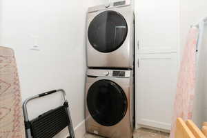 Laundry area with stacked washing machine and dryer