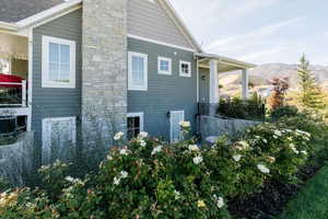 View of home's exterior with a central AC unit and a chimney