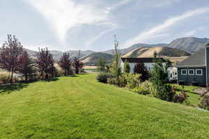 View of grassy yard with a mountain view
