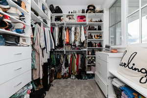 Spacious closet with light colored carpet