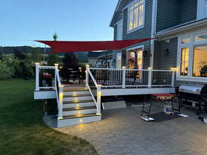 View of patio with area for grilling, a deck, and outdoor dining space