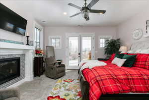 Carpeted bedroom with access to outside, multiple windows, french doors, a ceiling fan, and recessed lighting