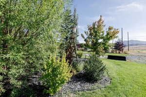 View of green lawn featuring a mountain view
