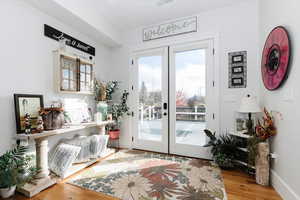 Doorway featuring french doors and wood finished floors