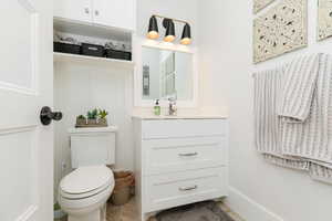 Half bathroom with vanity and toilet