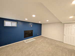 Below grade area featuring recessed lighting and carpet flooring