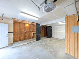 Garage with a garage door opener and electric panel