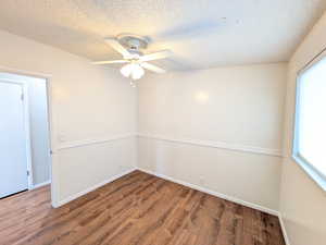 Bedroom featuring wood finished floors, a textured ceiling, and ceiling fan