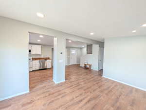 Unfurnished living room with light wood-style flooring and recessed lighting