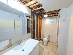 Unfinished Bathroom with toilet and vanity