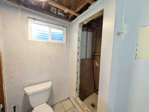 Bathroom with unfinished shower stall
