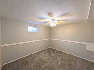 Unfurnished room with carpet, a textured ceiling, and ceiling fan