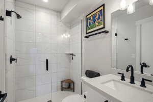 Full bath featuring vanity and a shower stall