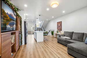 Living area featuring recessed lighting, light wood-type flooring, and stairway