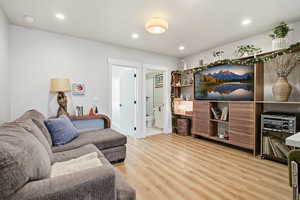 Living area featuring light wood finished floors and recessed lighting