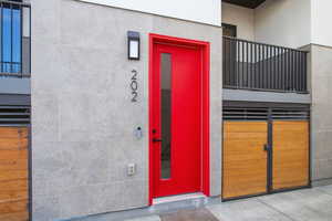 Property entrance featuring elevator and stucco siding